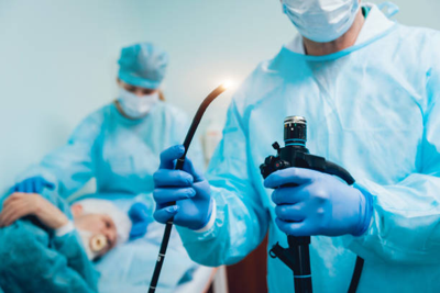 Picture | Dr Sandeep Nayak close-up of surgeons' gloved hands using a scalpel during an operation on a patient.